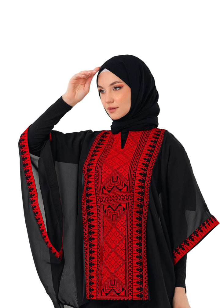 Woman wearing a black and red outfit with a hijab on a white background