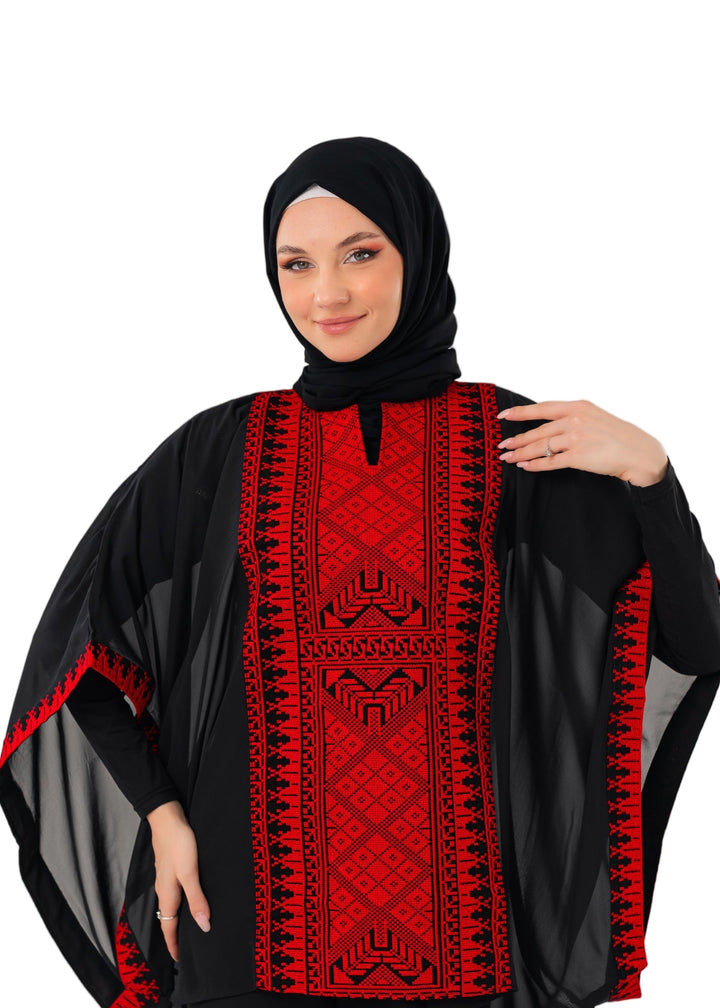 Woman wearing a black and red patterned top on a white background