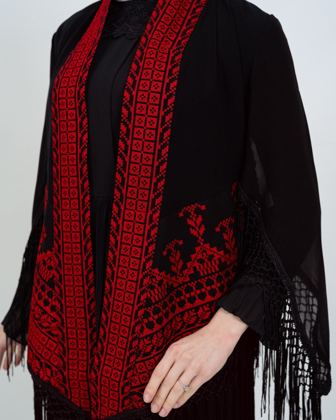 Shine with a touch of authenticity and heritage in this luxurious deep black jacket, adorned with rich and intricate Palestinian embroidery in vibrant red.