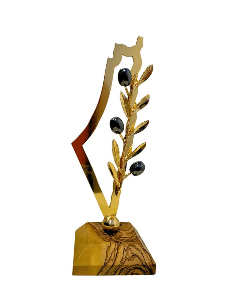 Decorative item with gold leaf design and black stones on a white background