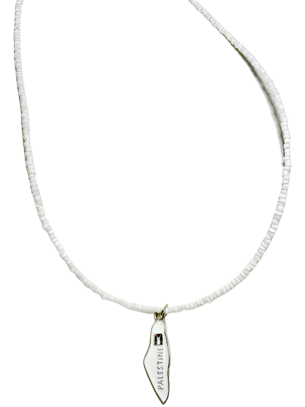 Necklace with a white beaded chain and a small pendant on a light gray background