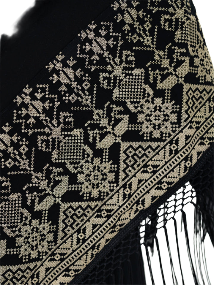 Shine with unique elegance with this luxurious shawl, which combines the splendor of classic black with the beauty of authentic Palestinian embroidery in radiant gold.