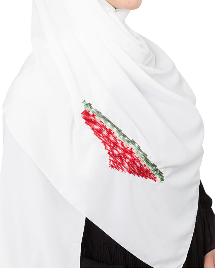An elegant light grey Shawl&nbsp;, made from high-quality polyester and measuring 70 x 180 cm. It features unique and beautiful embroidery of the map of Palestine, in colors inspired by the watermelon (red, green, black, and white), which has be