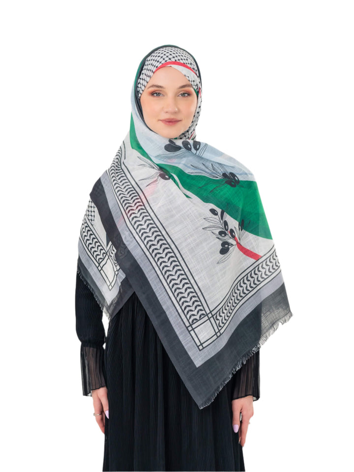 Elevate your look with this exquisite scarf crafted from the finest polyester, draping softly to offer a feeling of comfort and luxury. Measuring a perfect 70 x 180 cm, this scarf boasts a unique design that blends elegance with simplicity. It is beautifully adorned with an artistic print of an olive branch – a timeless symbol of peace, authenticity, and renewal – precisely printed on one side. More than just a piece of fabric, this scarf is an expression of sophisticated taste and a connection to nature an