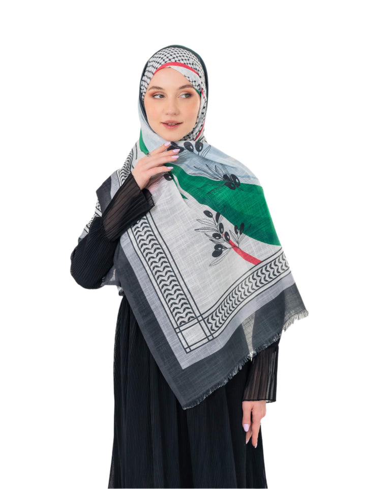 Elevate your look with this exquisite scarf crafted from the finest polyester, draping softly to offer a feeling of comfort and luxury. Measuring a perfect 70 x 180 cm, this scarf boasts a unique design that blends elegance with simplicity. It is beautifully adorned with an artistic print of an olive branch – a timeless symbol of peace, authenticity, and renewal – precisely printed on one side. More than just a piece of fabric, this scarf is an expression of sophisticated taste and a connection to nature an