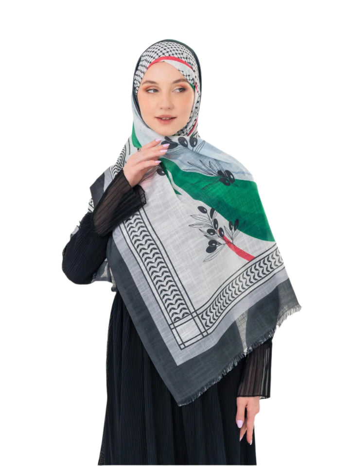 Elevate your look with this exquisite scarf crafted from the finest polyester, draping softly to offer a feeling of comfort and luxury. Measuring a perfect 70 x 180 cm, this scarf boasts a unique design that blends elegance with simplicity. It is beautifully adorned with an artistic print of an olive branch – a timeless symbol of peace, authenticity, and renewal – precisely printed on one side. More than just a piece of fabric, this scarf is an expression of sophisticated taste and a connection to nature an