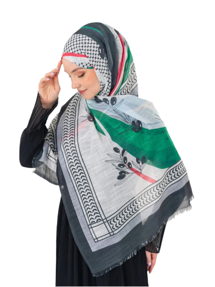 Elevate your look with this exquisite scarf crafted from the finest polyester, draping softly to offer a feeling of comfort and luxury. Measuring a perfect 70 x 180 cm, this scarf boasts a unique design that blends elegance with simplicity. It is beautifully adorned with an artistic print of an olive branch – a timeless symbol of peace, authenticity, and renewal – precisely printed on one side. More than just a piece of fabric, this scarf is an expression of sophisticated taste and a connection to nature an