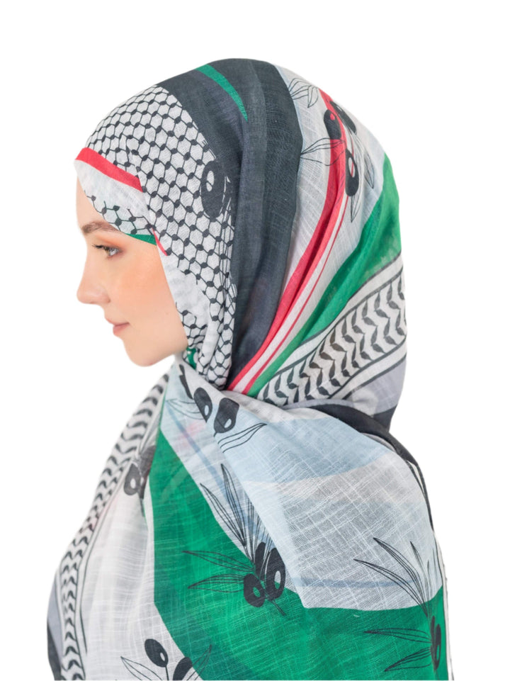 Elevate your look with this exquisite scarf crafted from the finest polyester, draping softly to offer a feeling of comfort and luxury. Measuring a perfect 70 x 180 cm, this scarf boasts a unique design that blends elegance with simplicity. It is beautifully adorned with an artistic print of an olive branch – a timeless symbol of peace, authenticity, and renewal – precisely printed on one side. More than just a piece of fabric, this scarf is an expression of sophisticated taste and a connection to nature an