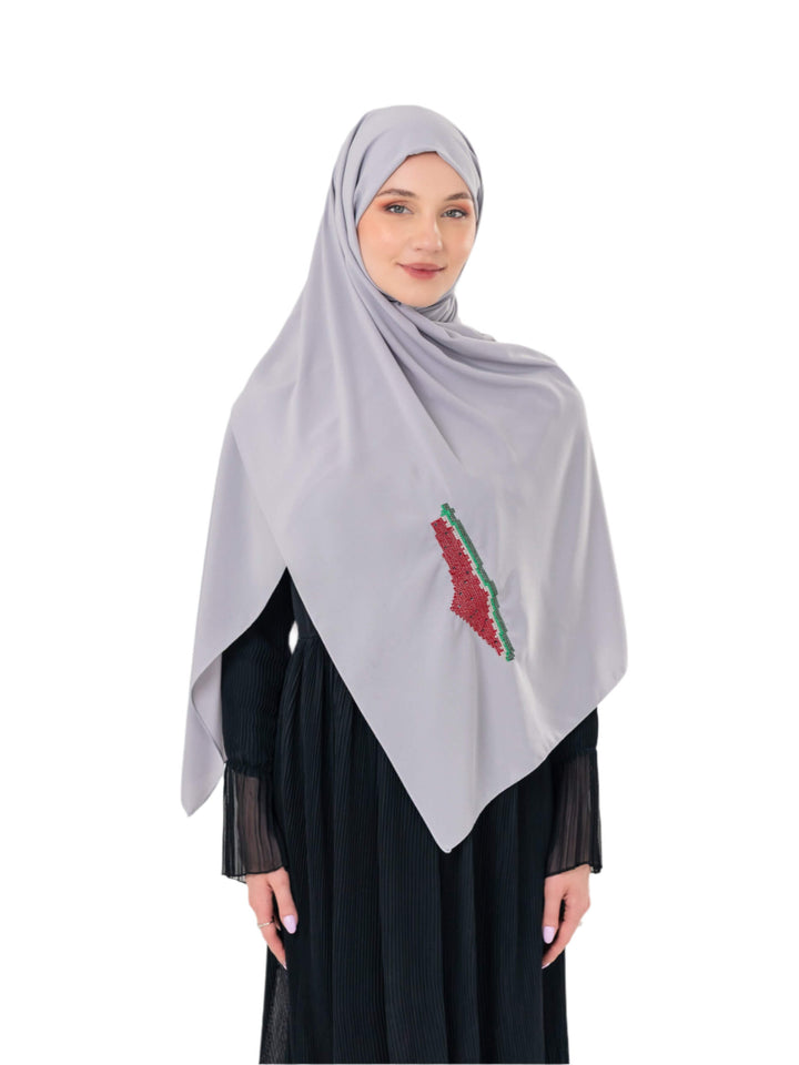 An elegant light grey scarf, made from high-quality polyester and measuring 70 x 180 cm. It features unique and beautiful embroidery of the map of Palestine, in colors inspired by the watermelon (red, green, black, and white), which has become a symbol of resistance and connection to Palestinian identity. This scarf adds a distinctive touch of elegance and deep meaning to your look.