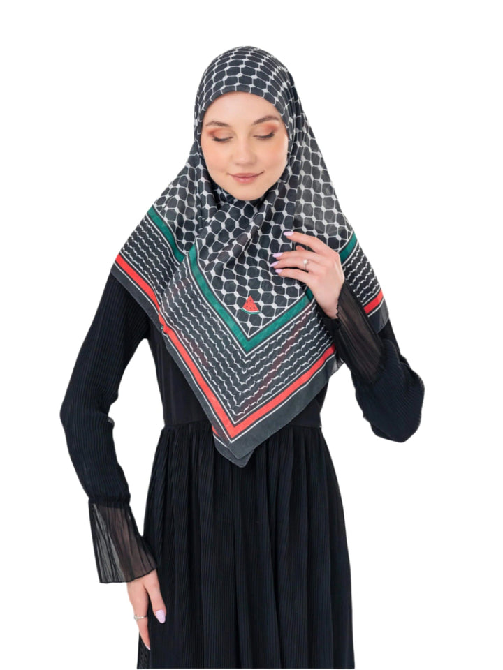 Woman wearing a black hijab with geometric pattern on a white background
