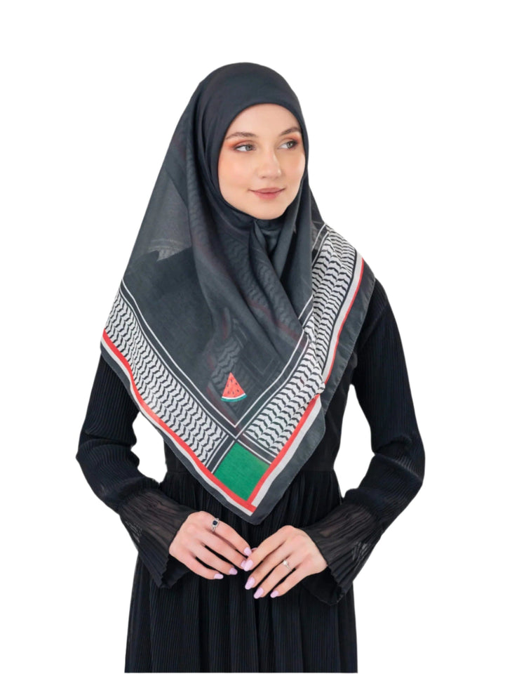 Woman wearing a black hijab with a geometric pattern on a white background