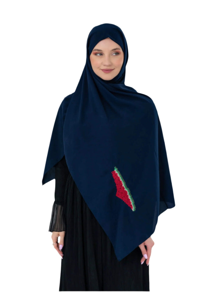 Woman wearing a dark blue hijab with a red and green design on a white background