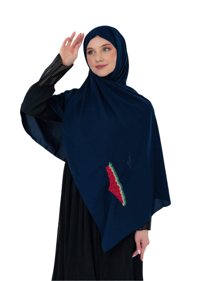 Woman wearing a navy blue hijab with a colorful design on a white background